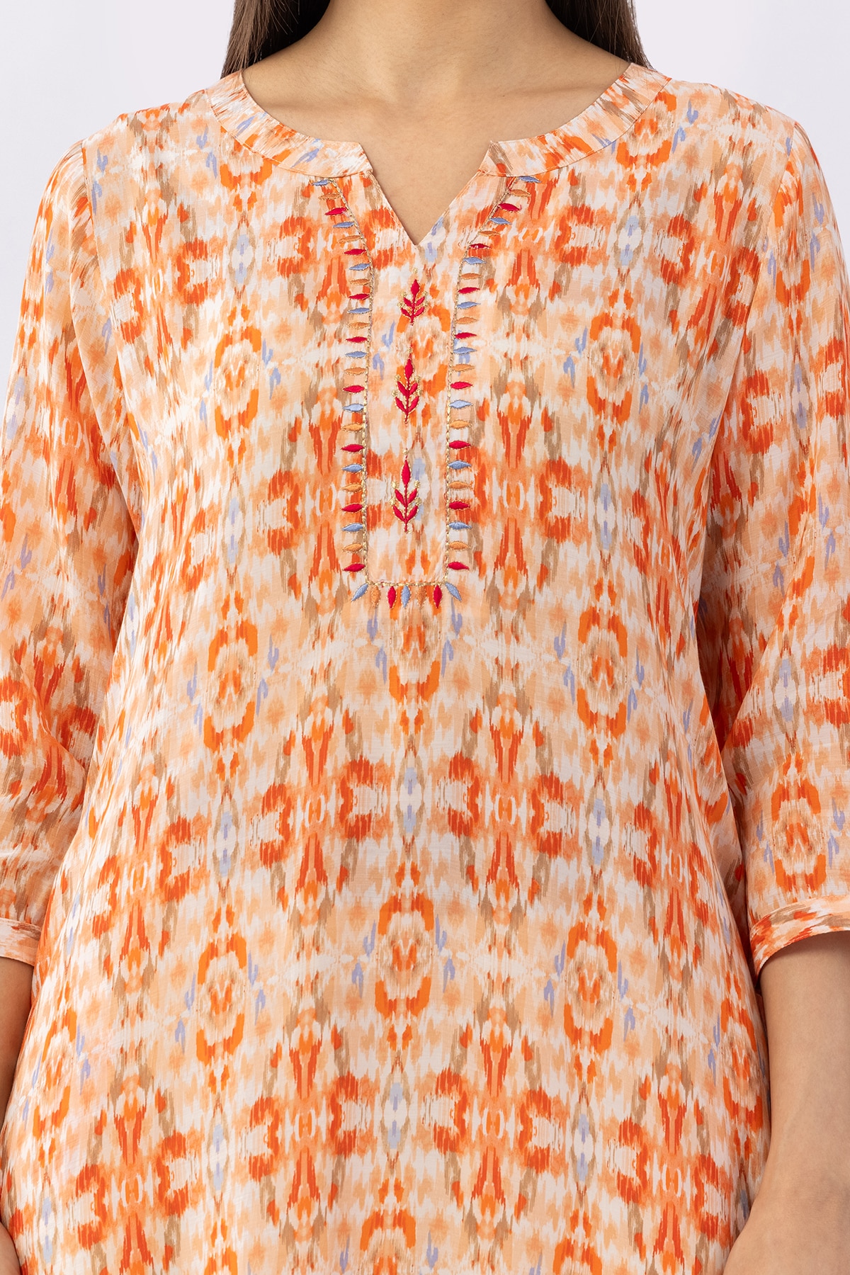 Embroidered orange viscose modal kurti for women with round neck and 3/4 sleeves